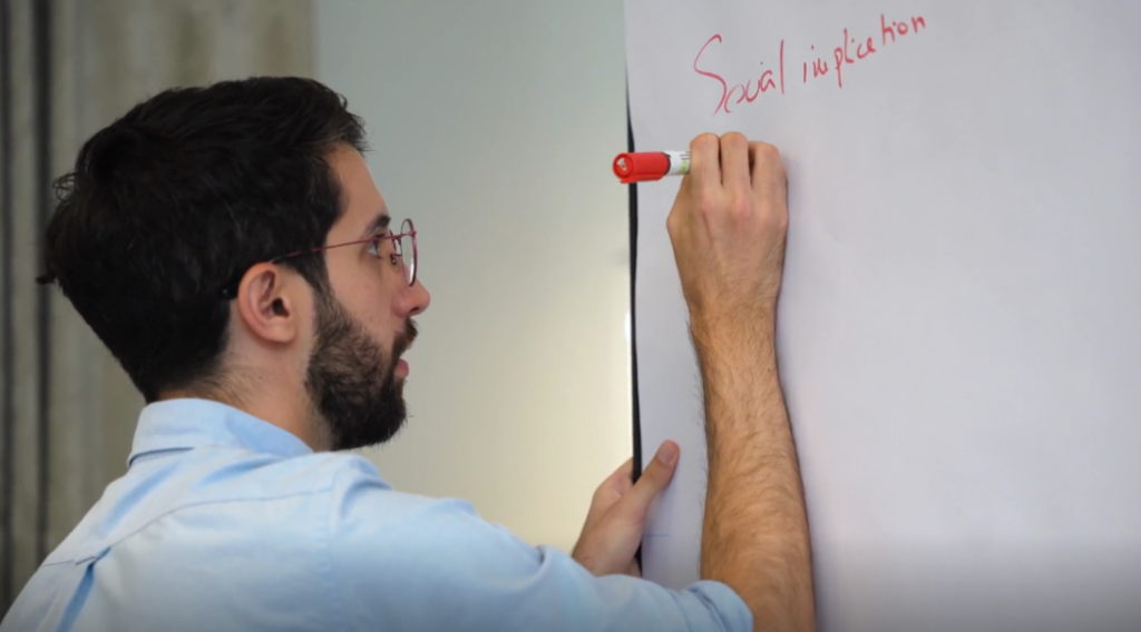 A person writes on a whiteboard at the blockchain training programme.