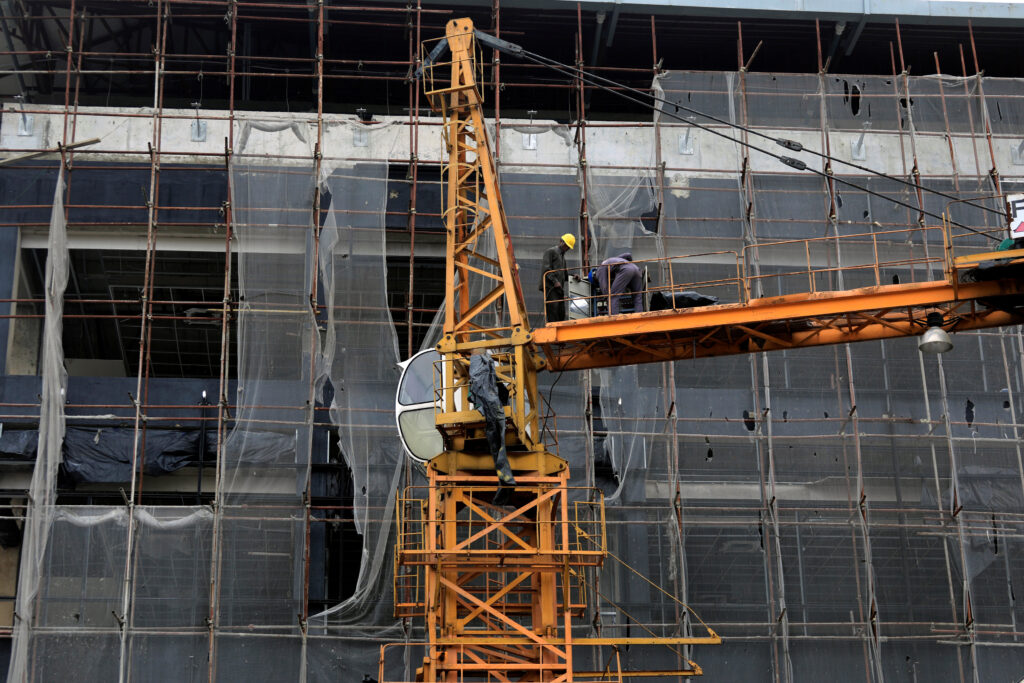 Construction workers stand on a crane as they work at a building site in Lekki, near Lagos, Nigeria September 12, 2017. Picture taken September 12, 2017.