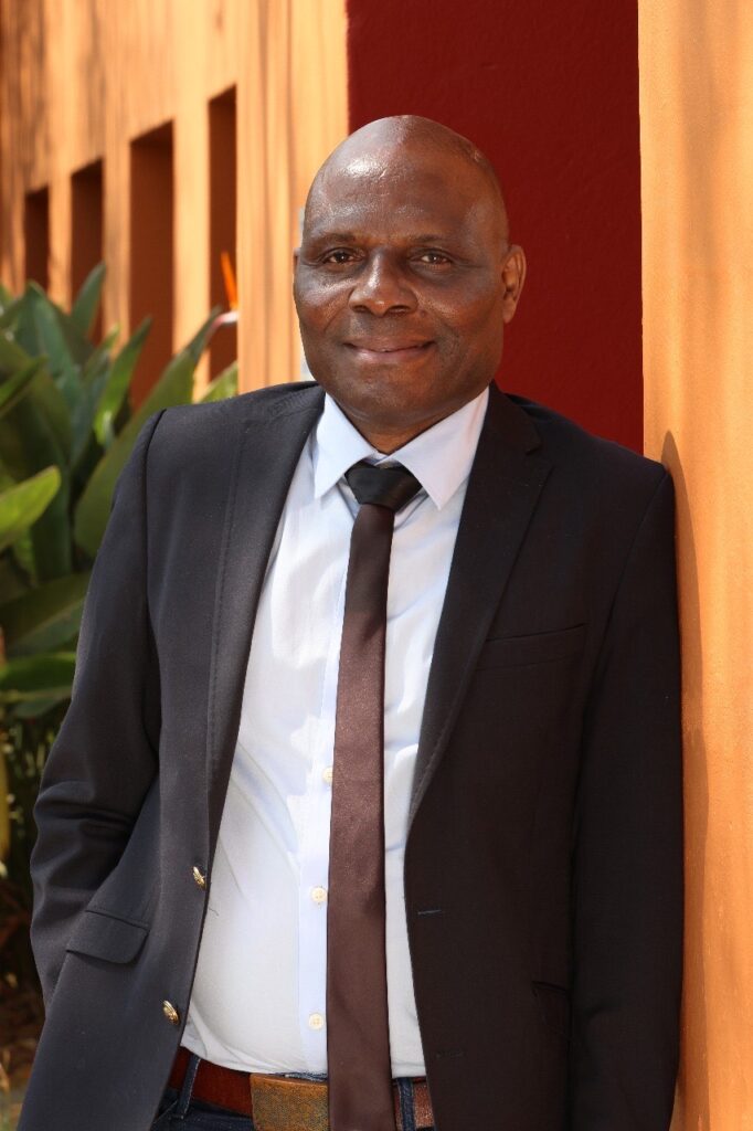 Journalist Fidelis Zvomuya is smiling whilst posing for a photo